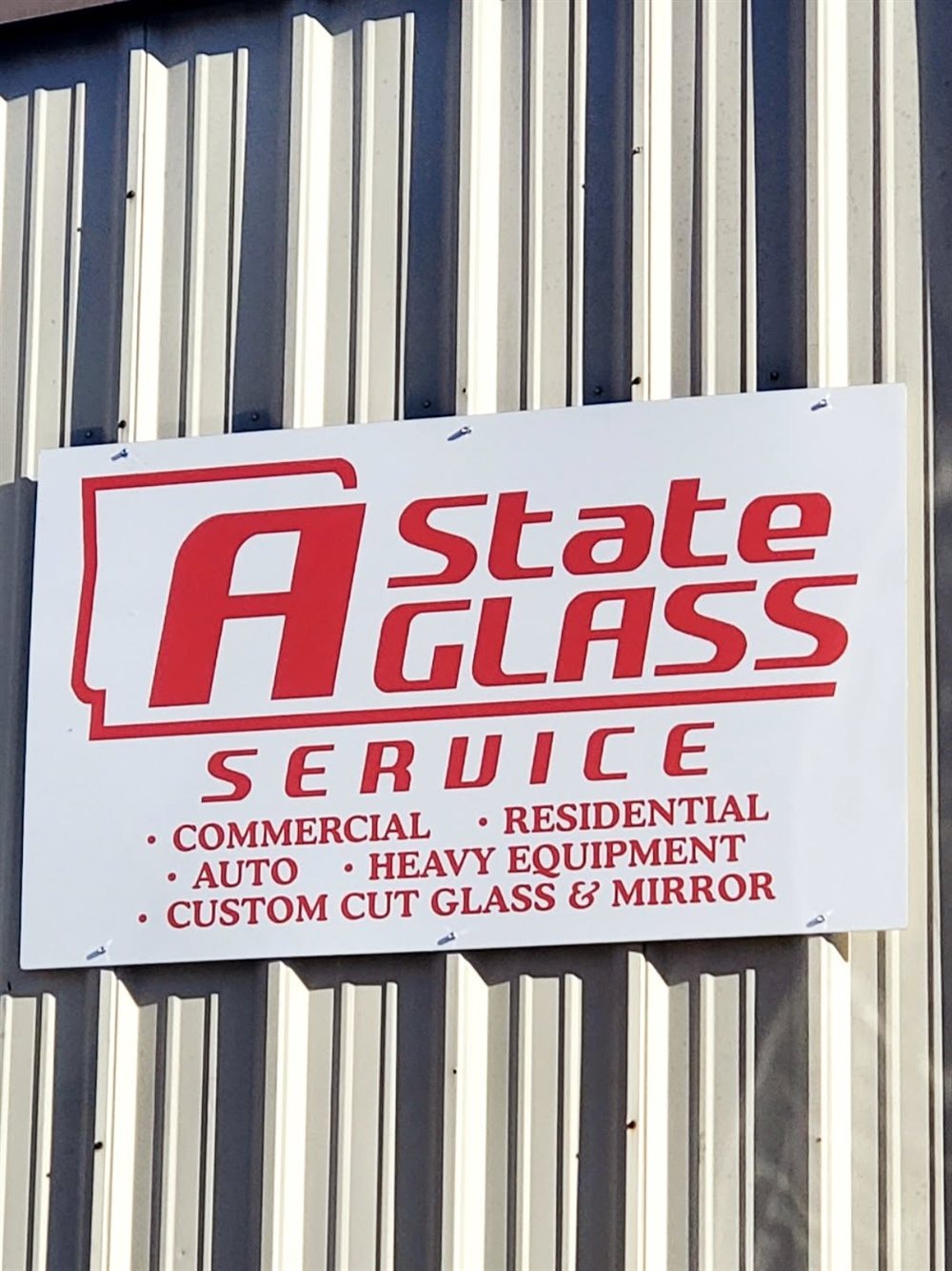A State Glass Service sign listing commercial, residential, auto, heavy equipment, and custom cut glass & mirror services